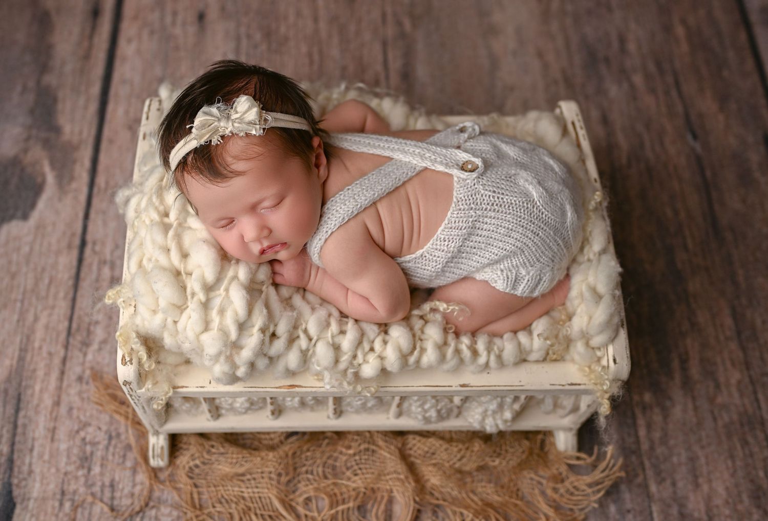 Newborn in white crib